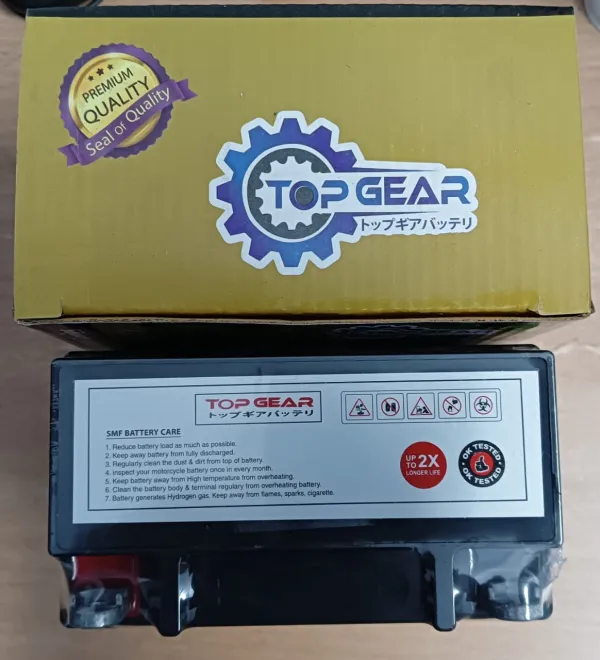 A TOP GEAR motorcycle battery displayed with its retail package